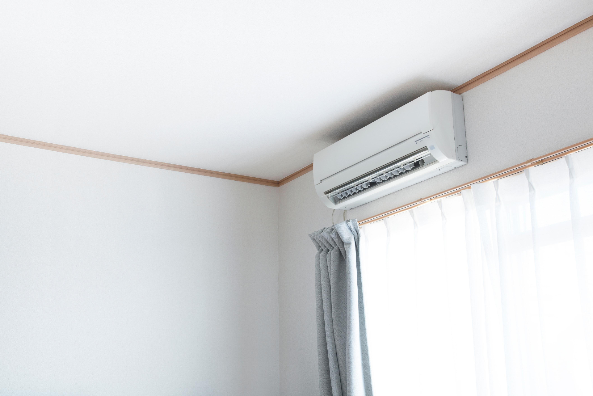Wall-mounted air conditioning unit in a bright residential room.